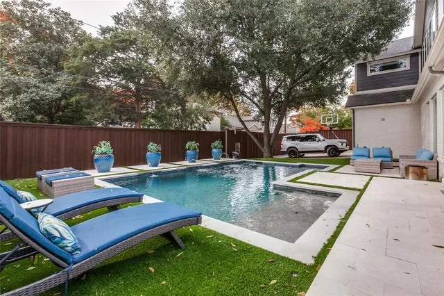 a view of a backyard with sitting area