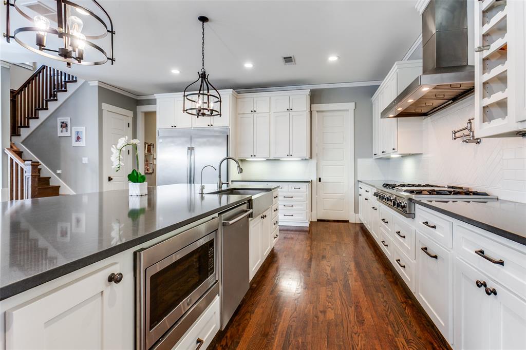 413 Ridge Crest Drive Richardson, TX 75080 - Photo 7 of 34 a large kitchen with stainless steel appliances granite countertop a lot of counter space and wooden floors