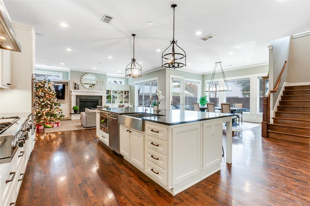 413 Ridge Crest Drive Richardson, TX 75080 - Photo 10 of 34 a kitchen with stainless steel appliances granite countertop a stove oven and a wooden floor