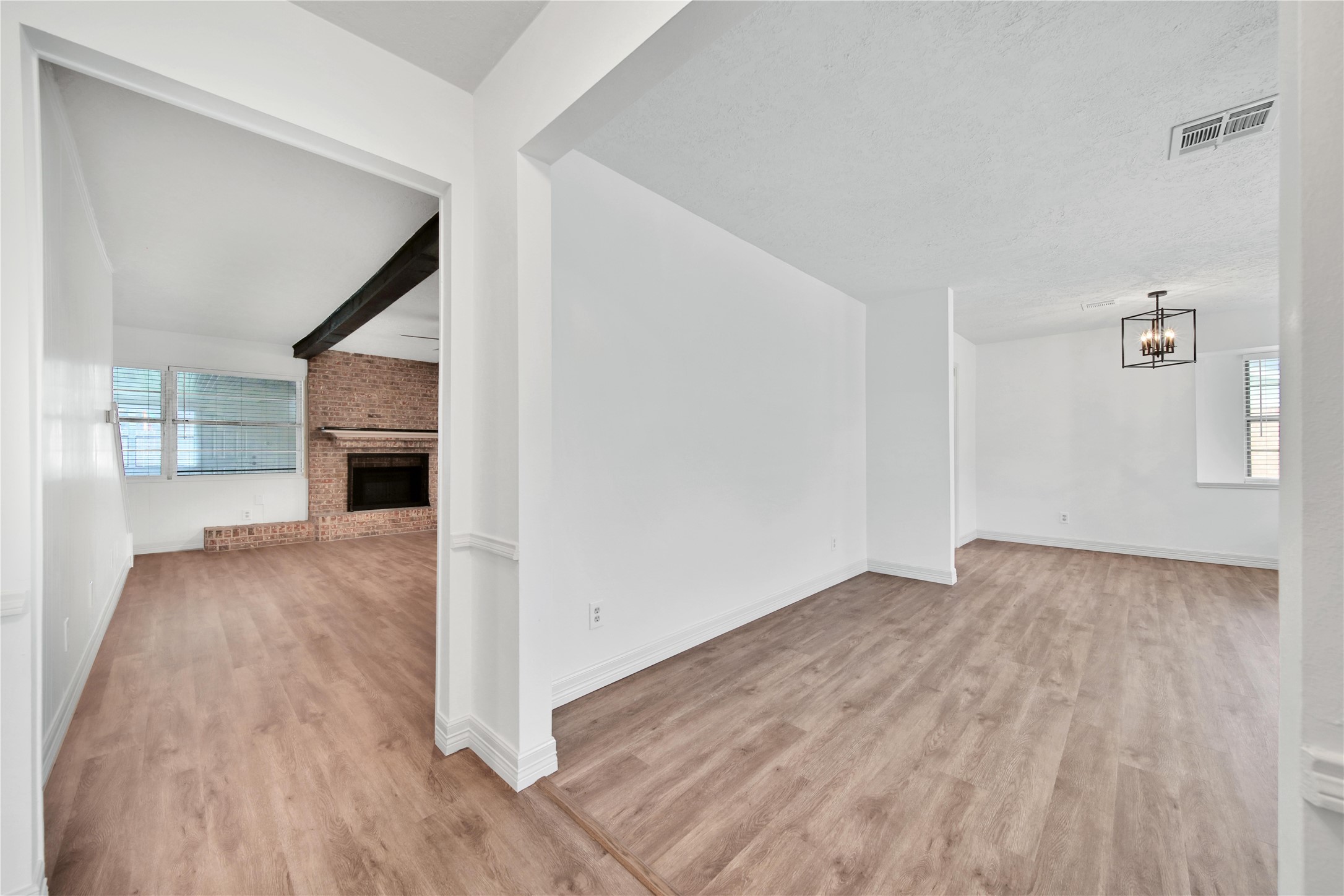 9411 Roos Road Houston, TX 77036 - Photo 11 of 41 a view of empty room with wooden floor and fireplace