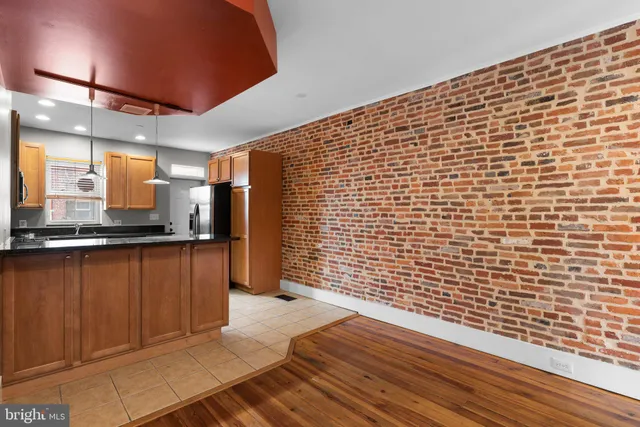 a view of a refrigerator in kitchen and wooden floor