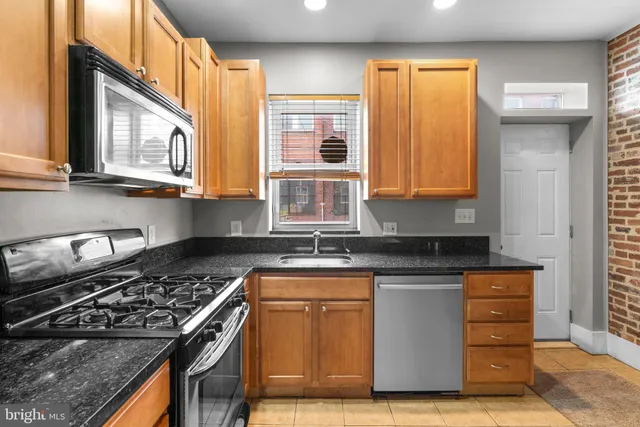 a kitchen with stainless steel appliances granite countertop a stove and a sink