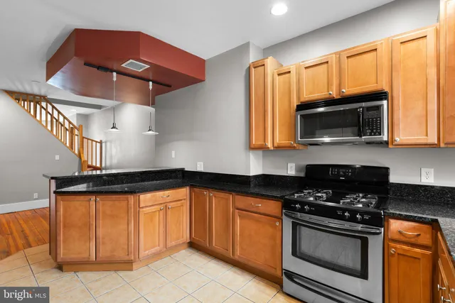 a kitchen with stainless steel appliances granite countertop a sink and cabinets