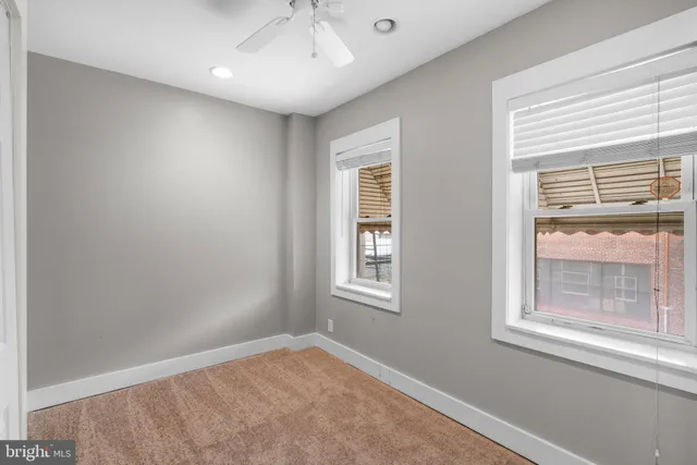 an empty room with windows and closet