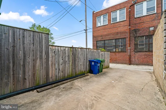 a view of a brick house with a small yard