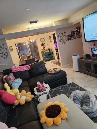 a living room with furniture and air hockey table
