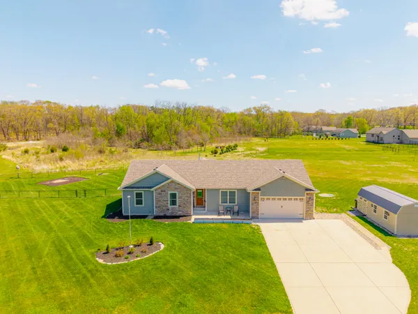 a front view of a house with a big yard