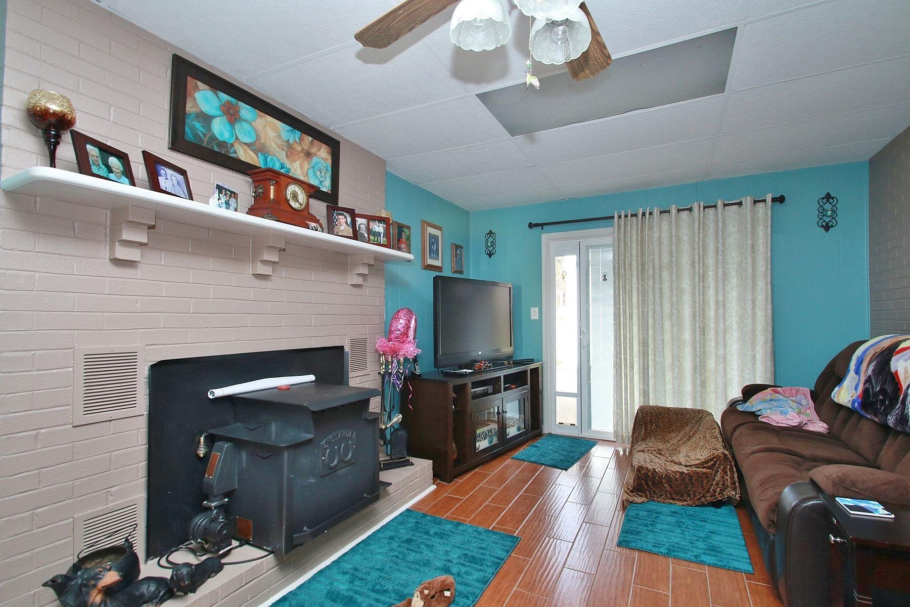 525 Olney Road Vinton, VA 24179 - Photo 8 of 17 a living room with furniture a flat screen tv and a fireplace
