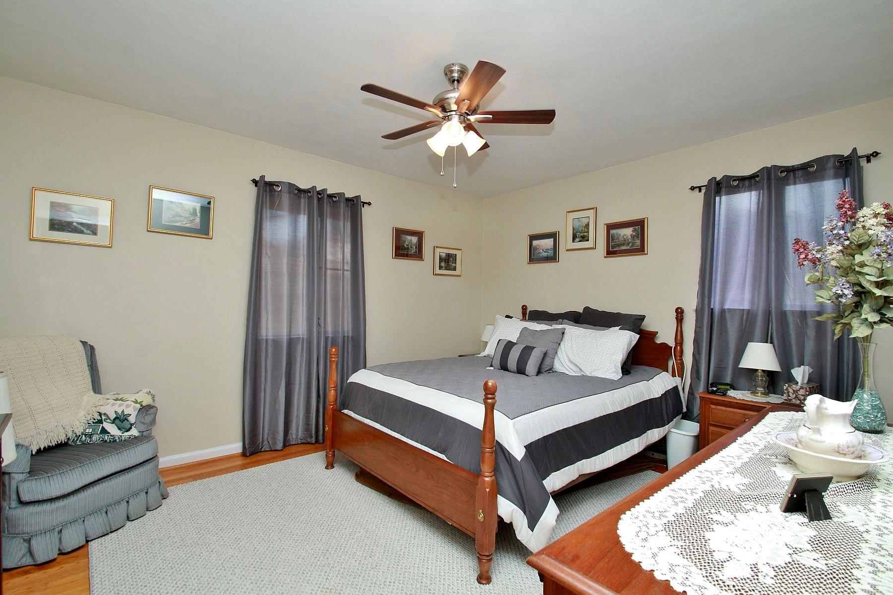 525 Olney Road Vinton, VA 24179 - Photo 9 of 17 a bedroom with a bed and a chandelier