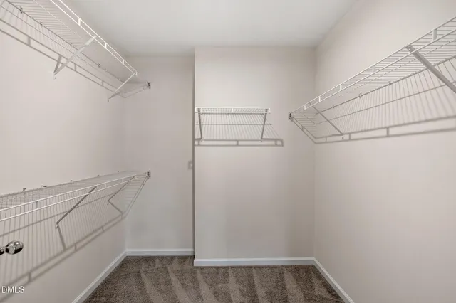 a view of empty room with closet and fan