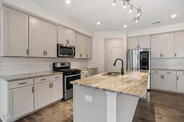 a kitchen with granite countertop a stove and a sink
