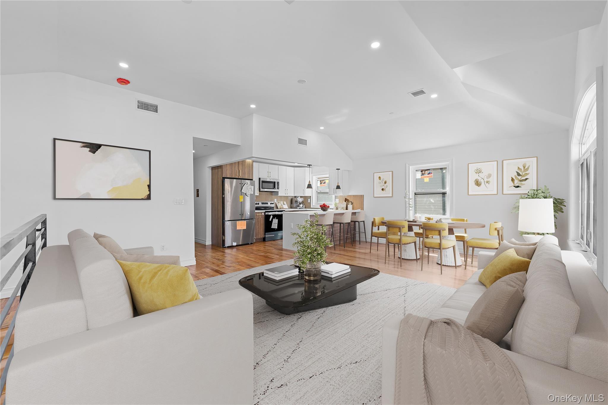 258-10 147th Road Queens, NY 11422 - Photo 12 of 26 Living room featuring vaulted ceiling, light wood-style floors, and recessed lighting
