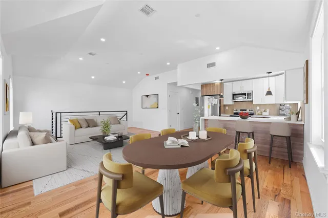 a living room with furniture kitchen view and a table