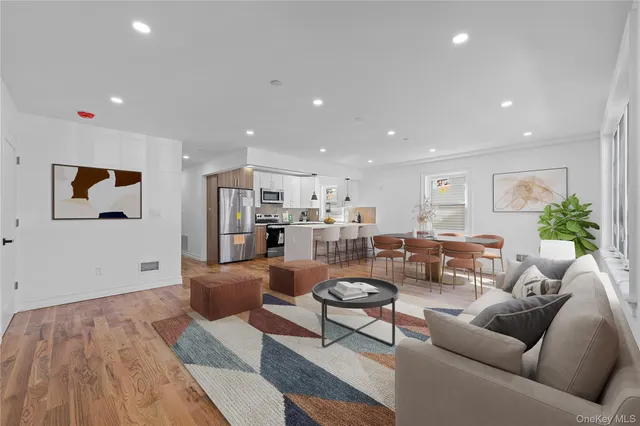 a living room with furniture and kitchen view