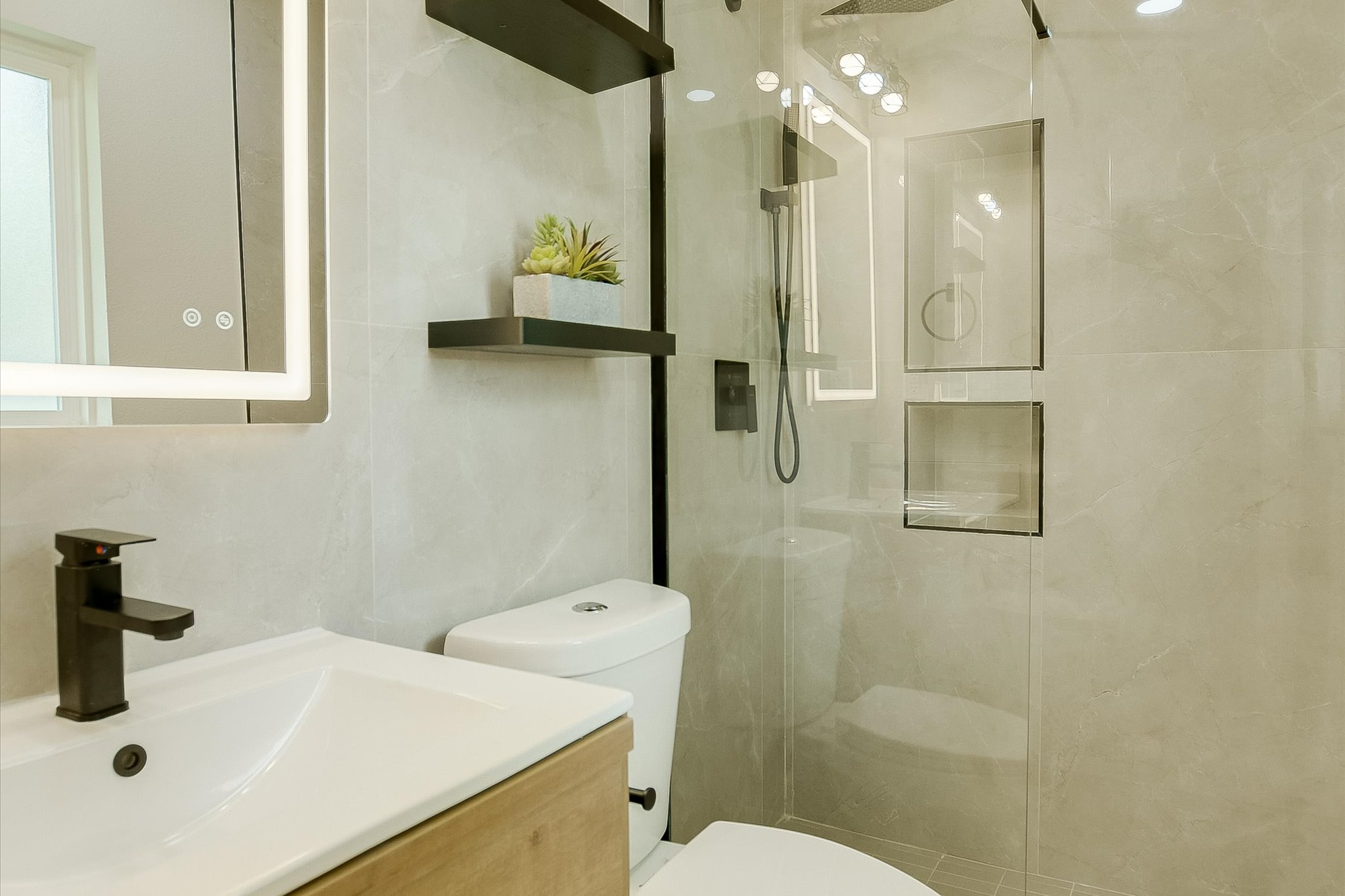 4505 Kitty Avenue Austin, TX 78721 - Photo 7 of 11 A well-appointed bath features a sleek vanity, modern fixtures, and a spacious shower.