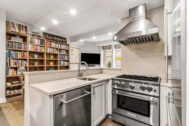 a living room with fireplace furniture and a book shelf