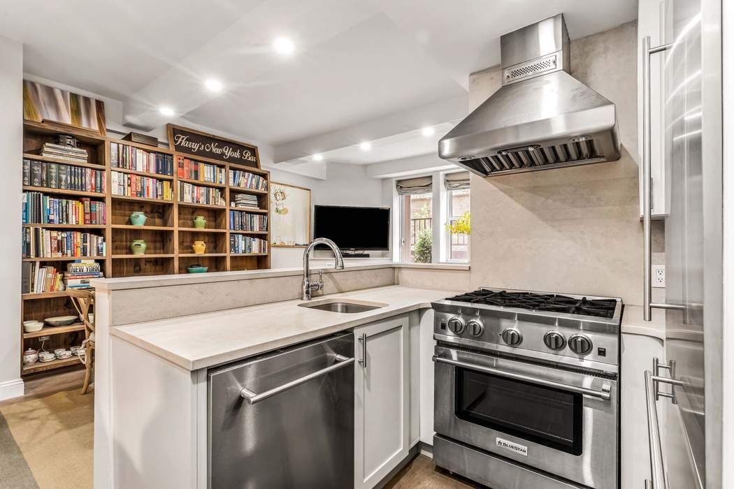 64 East 94th Street, Unit 1G Manhattan, NY 10128 - Photo 4 of 11 a kitchen with a stove and a sink