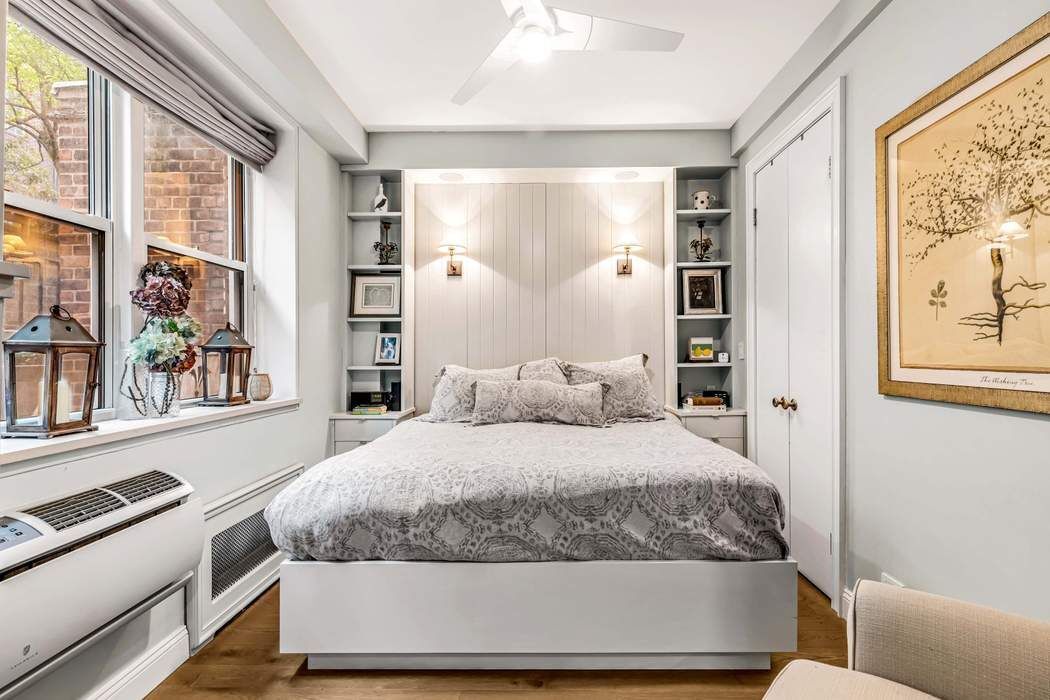 64 East 94th Street, Unit 1G Manhattan, NY 10128 - Photo 6 of 11 a bedroom with a large bed and a window