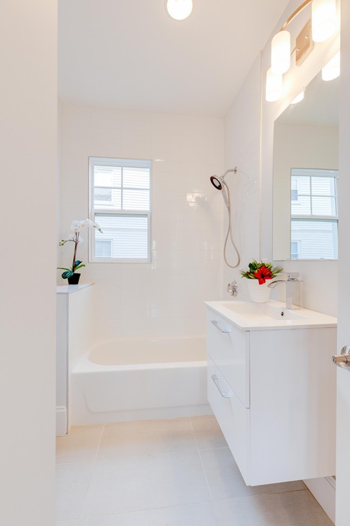 57 Katherine Road, Unit 57 Watertown, MA 02472 - Photo 15 of 30 a bathroom with a bathtub a sink and a mirror