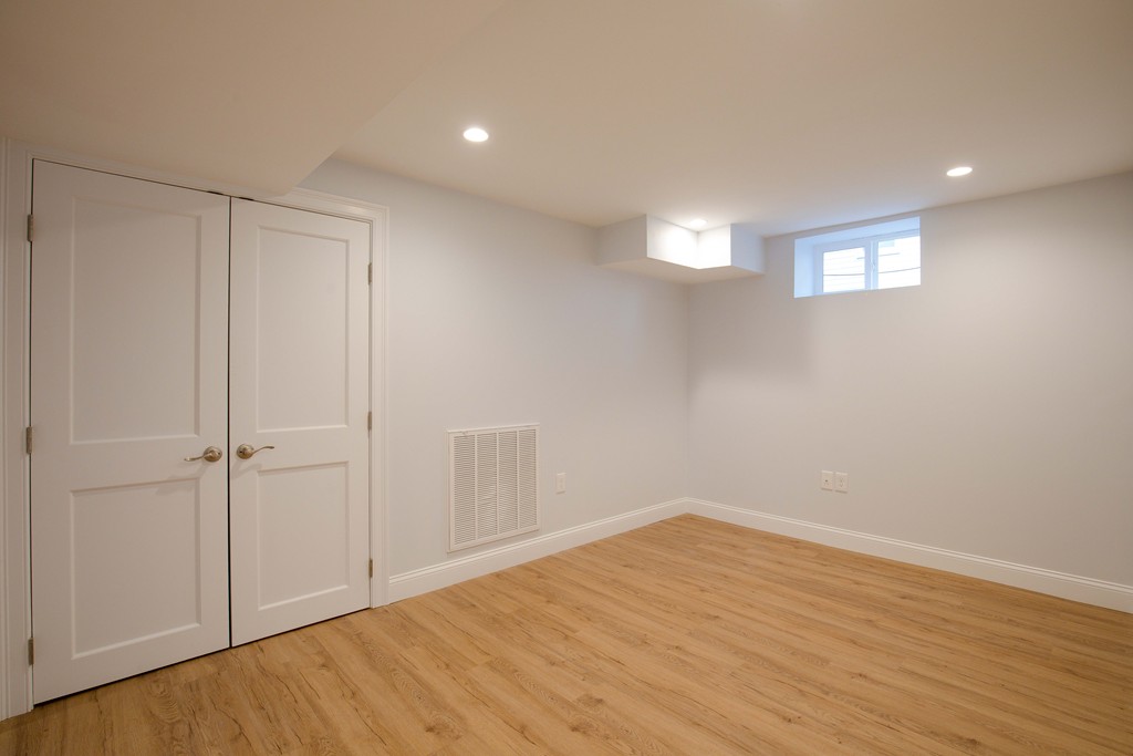 57 Katherine Road, Unit 57 Watertown, MA 02472 - Photo 20 of 30 a view of an empty room with wooden floor and closet