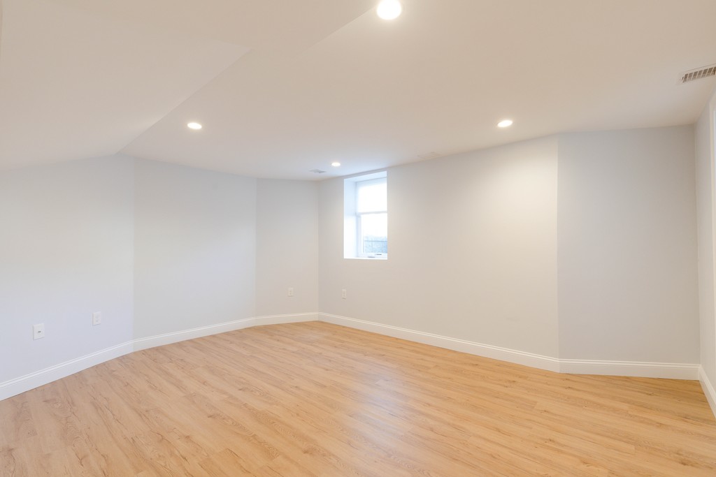 57 Katherine Road, Unit 57 Watertown, MA 02472 - Photo 26 of 30 a view of empty room with wooden floor and fan