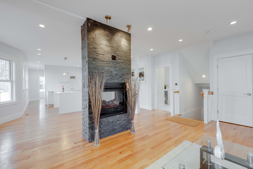 57 Katherine Road, Unit 57 Watertown, MA 02472 - Photo 5 of 30 a view of livingroom with hardwood floor and a fireplace