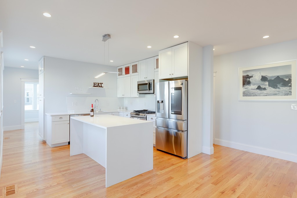 57 Katherine Road, Unit 57 Watertown, MA 02472 - Photo 6 of 30 a view of kitchen with stainless steel appliances granite countertop a refrigerator and a stove top oven