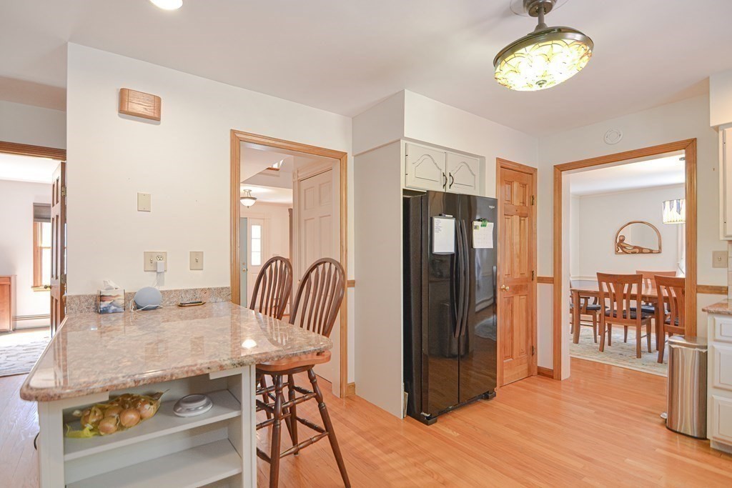 27 Wilson Pond Road Rowley, MA 01969 - Photo 19 of 42 a view of a dining room with furniture window and wooden floor