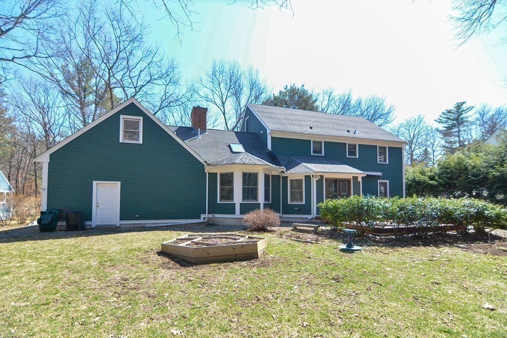 27 Wilson Pond Road Rowley, MA 01969 - Photo 5 of 42 a front view of a house with yard and trees in the background