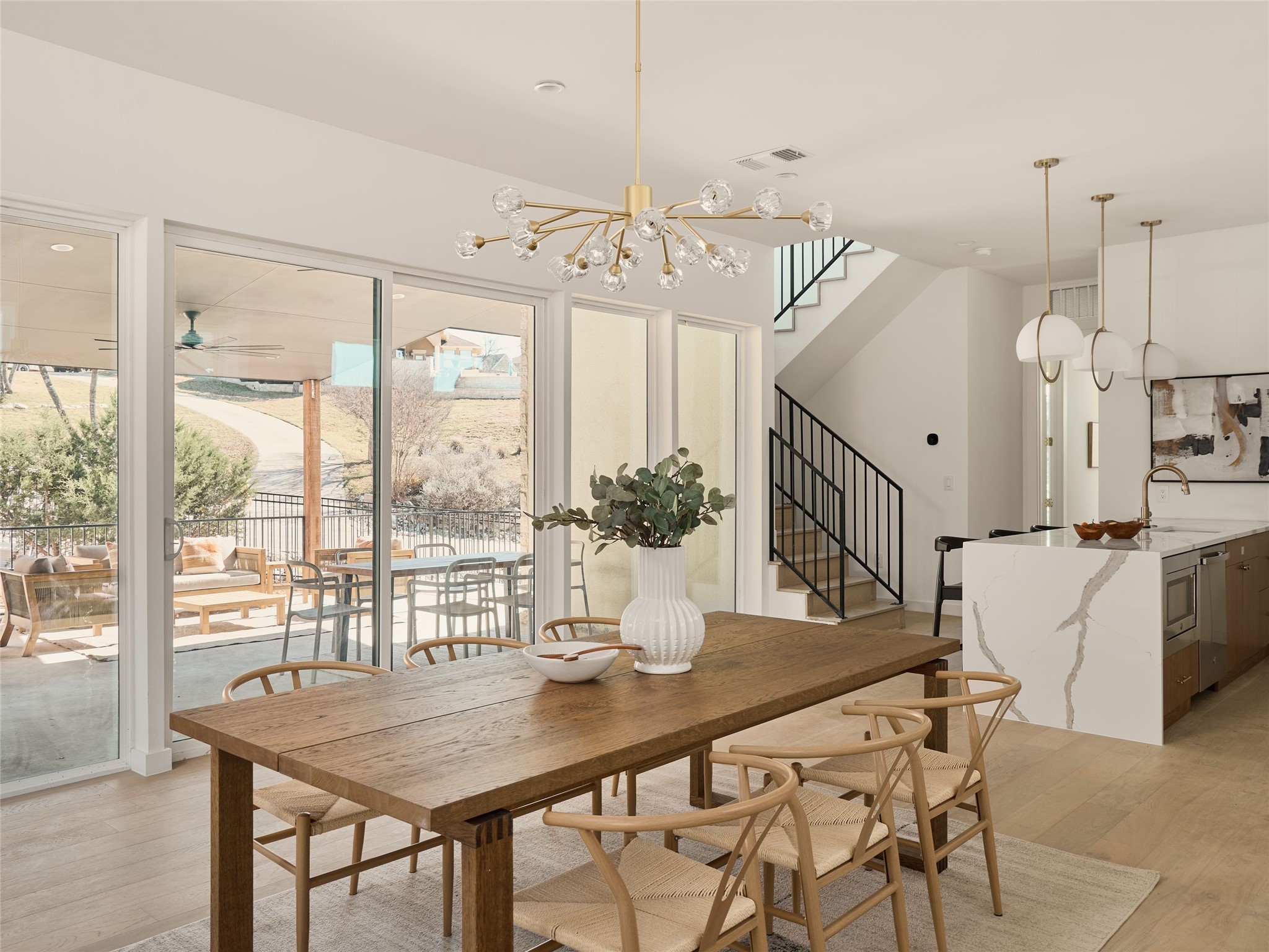 2100 Bighorn Leander, TX 78641 - Photo 6 of 36 Dining room with light wood-style flooring, a chandelier, stairs, and ceiling fan