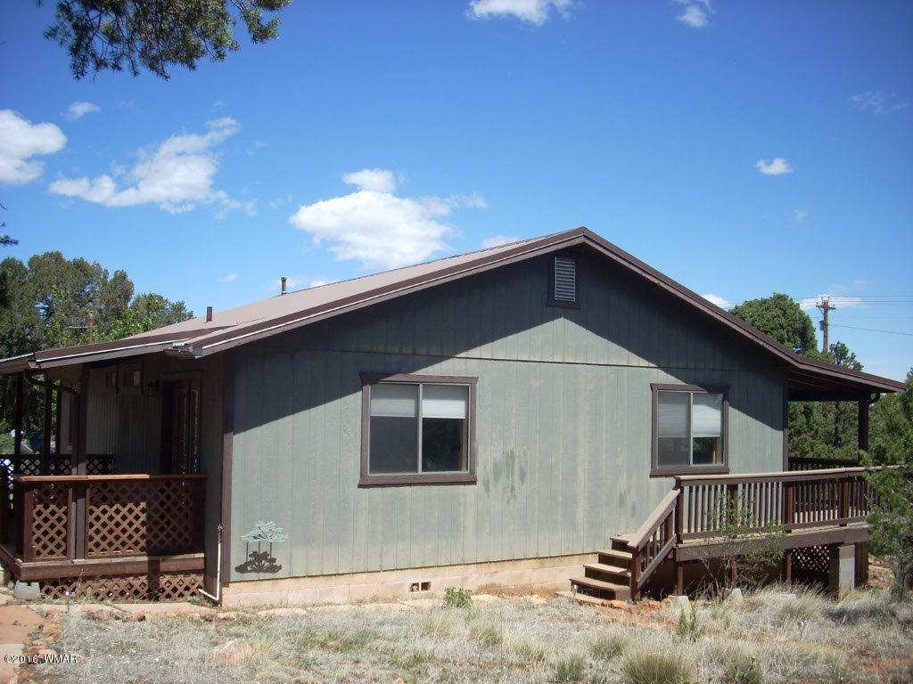 3145 Aspen Road Overgaard, AZ 85933 - Photo 12 of 36 a front view of a house with garage