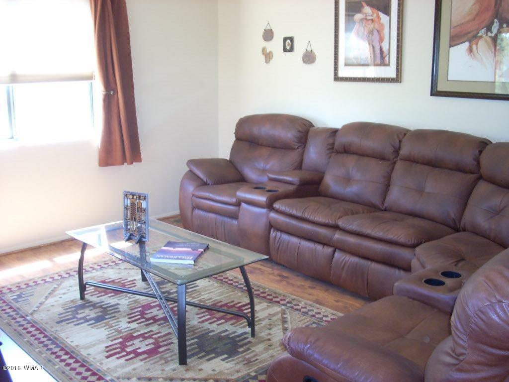3145 Aspen Road Overgaard, AZ 85933 - Photo 21 of 36 a living room with furniture a rug and a window