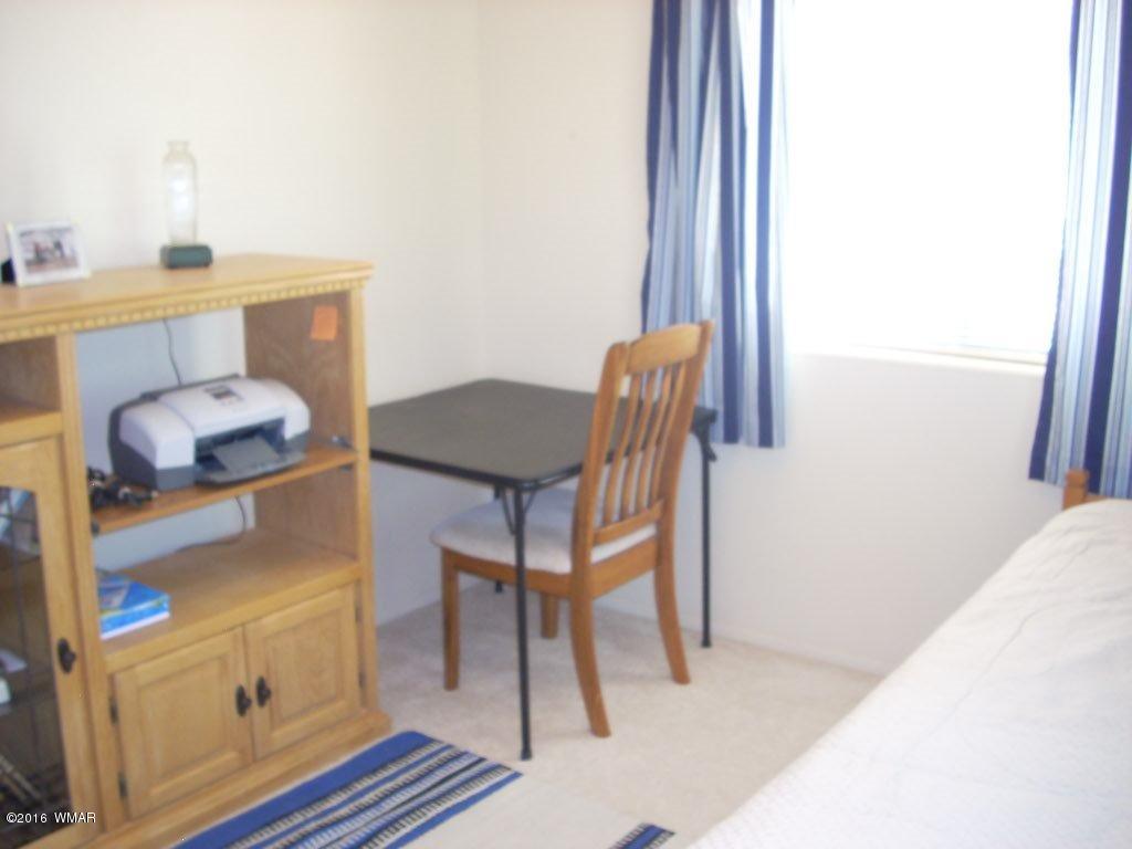 3145 Aspen Road Overgaard, AZ 85933 - Photo 30 of 36 a room with furniture and a window