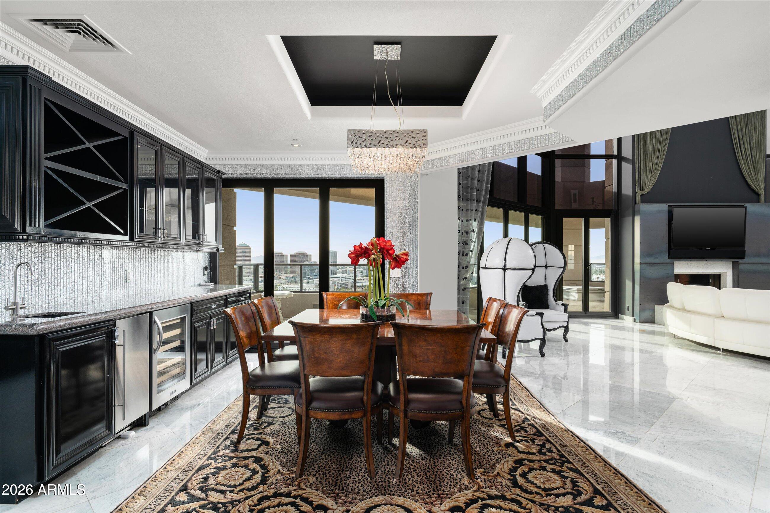 1040 East Osborn Road, Unit 1901 Phoenix, AZ 85014 - Photo 7 of 34 a dining room with furniture and wooden floor