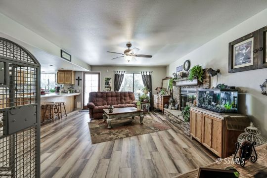 1213 Andrea Court Ridgecrest, CA 93555 - Photo 13 of 50 a living room with furniture and a wooden floor