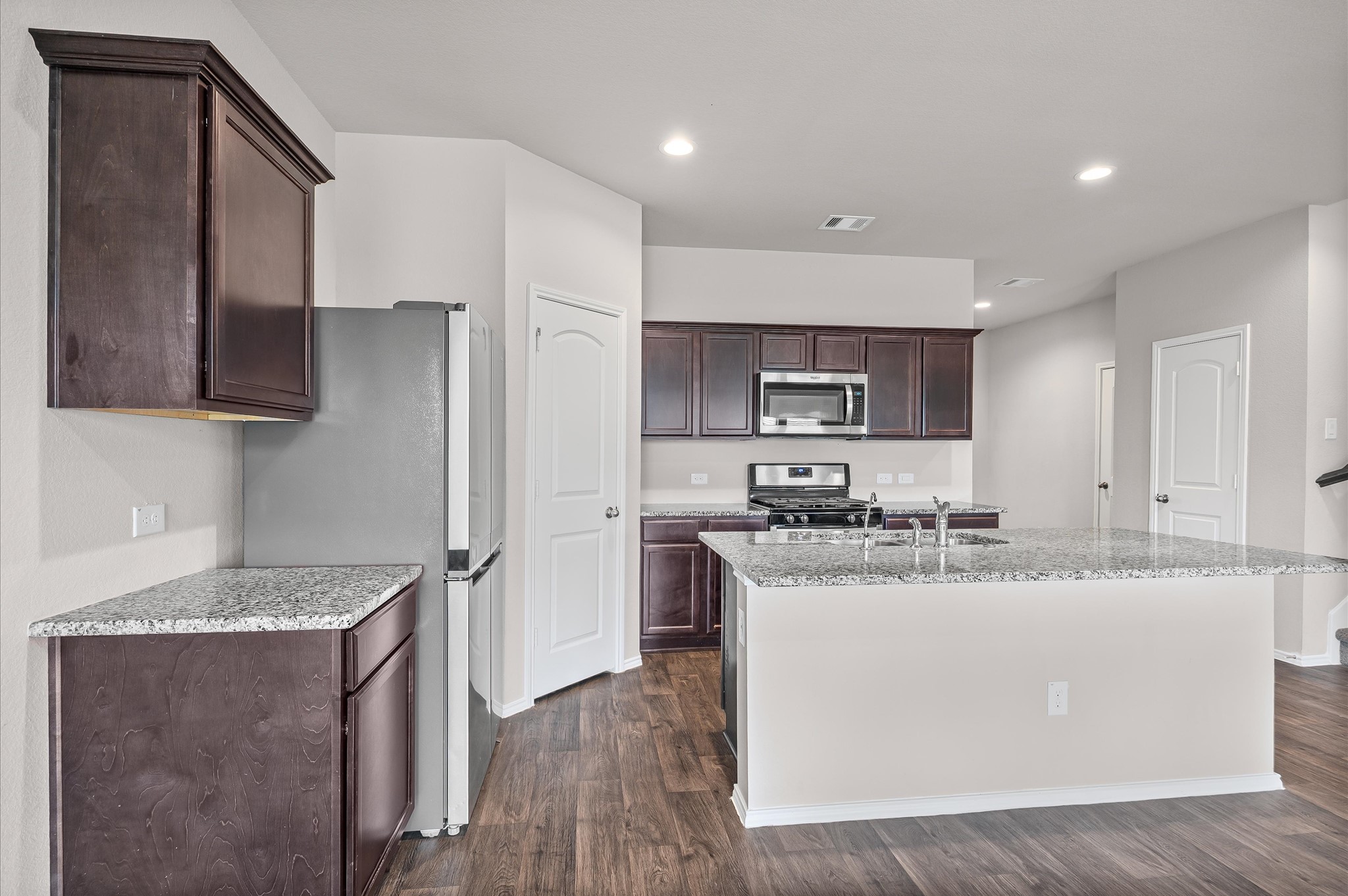 23522 Wedgewood Cliff Way Spring, TX 77373 - Photo 11 of 30 a kitchen with stainless steel appliances granite countertop a sink stove and refrigerator