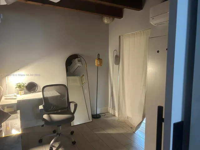 a room with a chair and a mirror