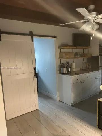 a view of a room with wooden floor