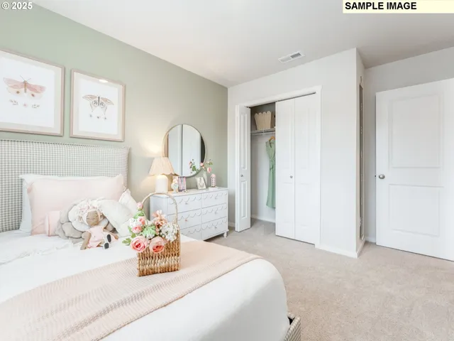 a bedroom with bed and cupboard