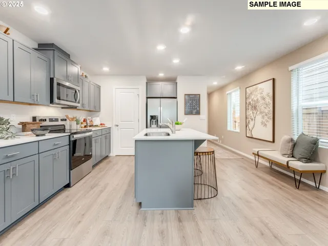 a kitchen with a sink cabinets and wooden floor