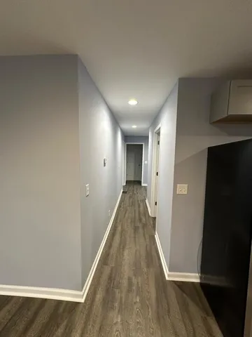 a view of hallway with wooden floor