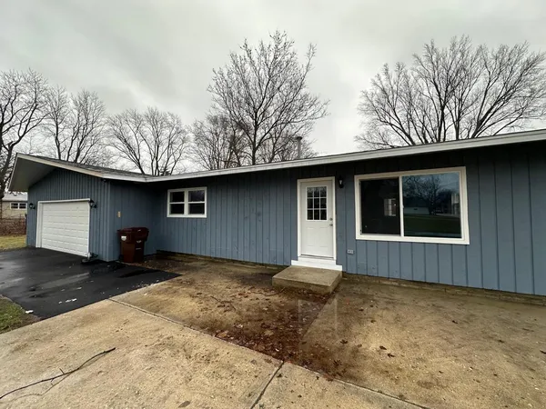 a house with trees in the background