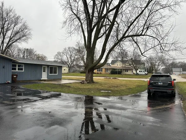 a view of a parked car in front of a house