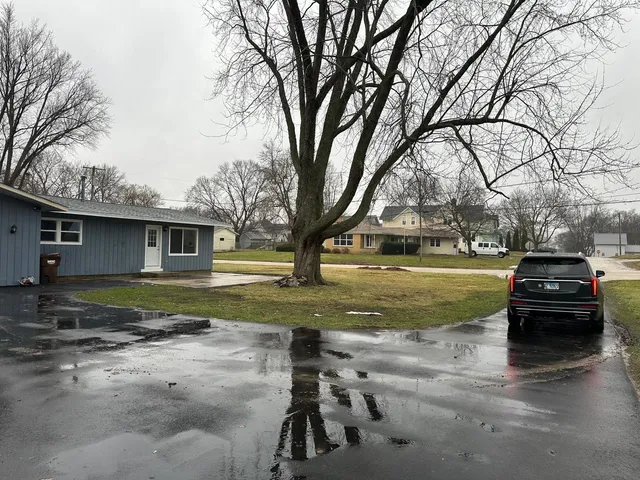a view of a parked car in front of a house