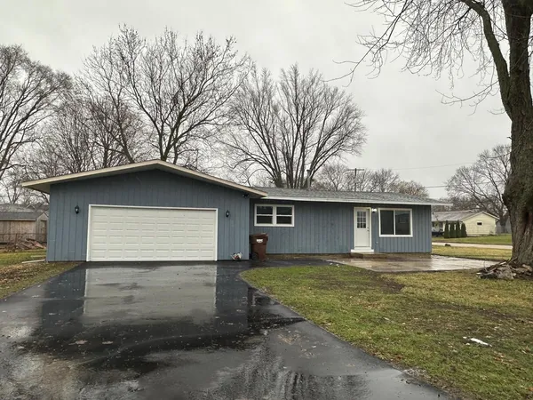a house that has a tree in front of the house