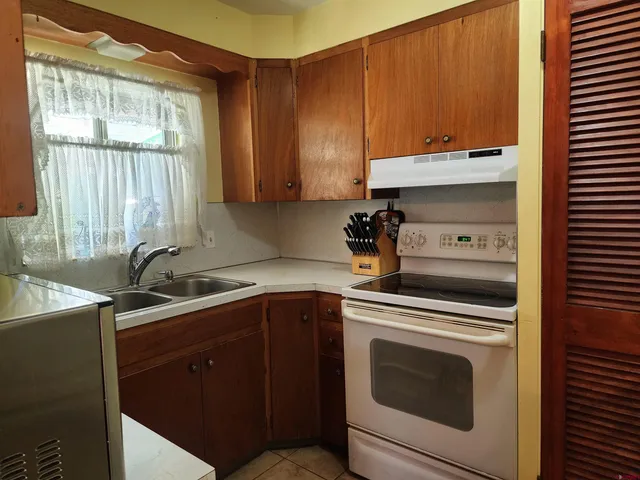 a kitchen with a sink stove and cabinets