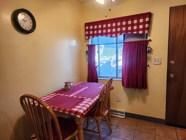 a dining room with a wooden table and a chair
