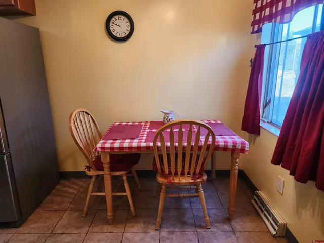 a view of a dining room with furniture and window