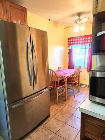 a dining room with a refrigerator and a table