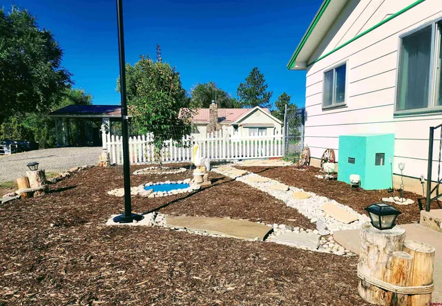 a view of a house with backyard and sitting area